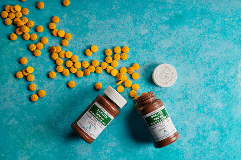 Beelith magnesium supplement bottles and tablets on blue background